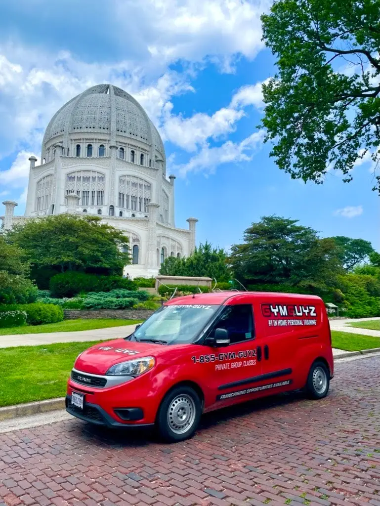 GYMGUYZ In-Home Personal Training Red GYMGUYZ van in front of the Baha'i Temple.