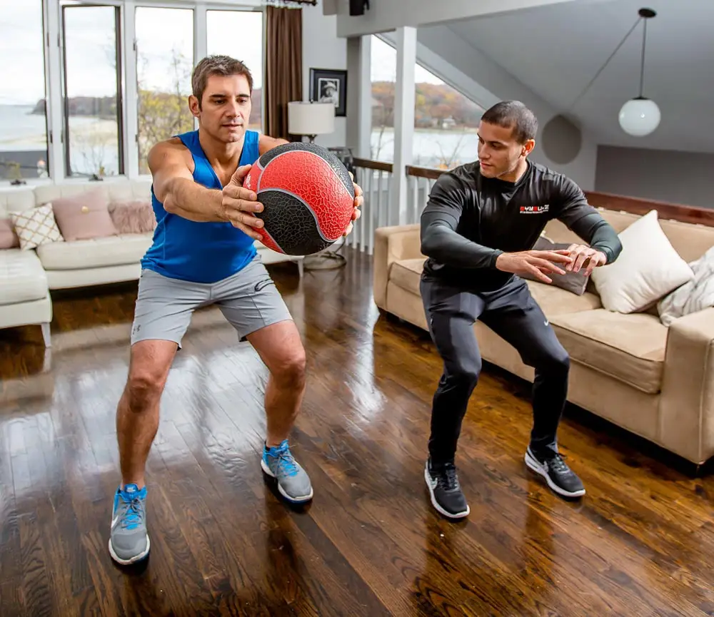 GYMGUYZ In-Home Personal Training Man training at home with a certified personal trainer.